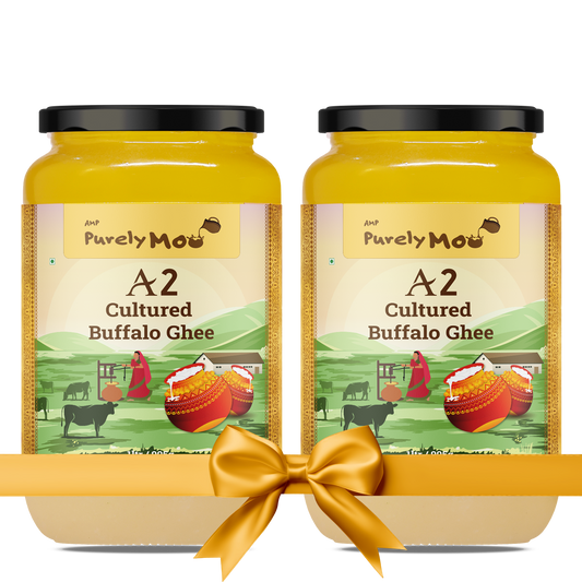 Two jars of Purely Moo's A2 Cultured Buffalo Ghee, elegantly packaged with a gold ribbon, showcasing its premium quality.